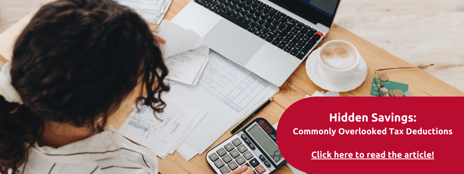desk with laptop and work papers.