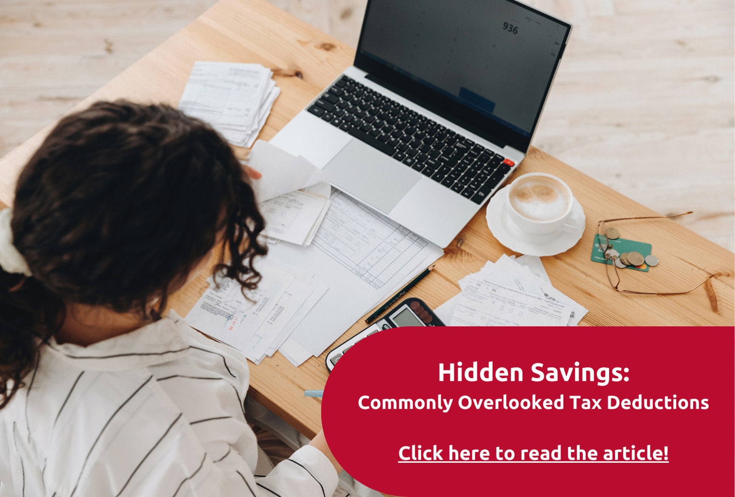 desk with laptop and work papers.